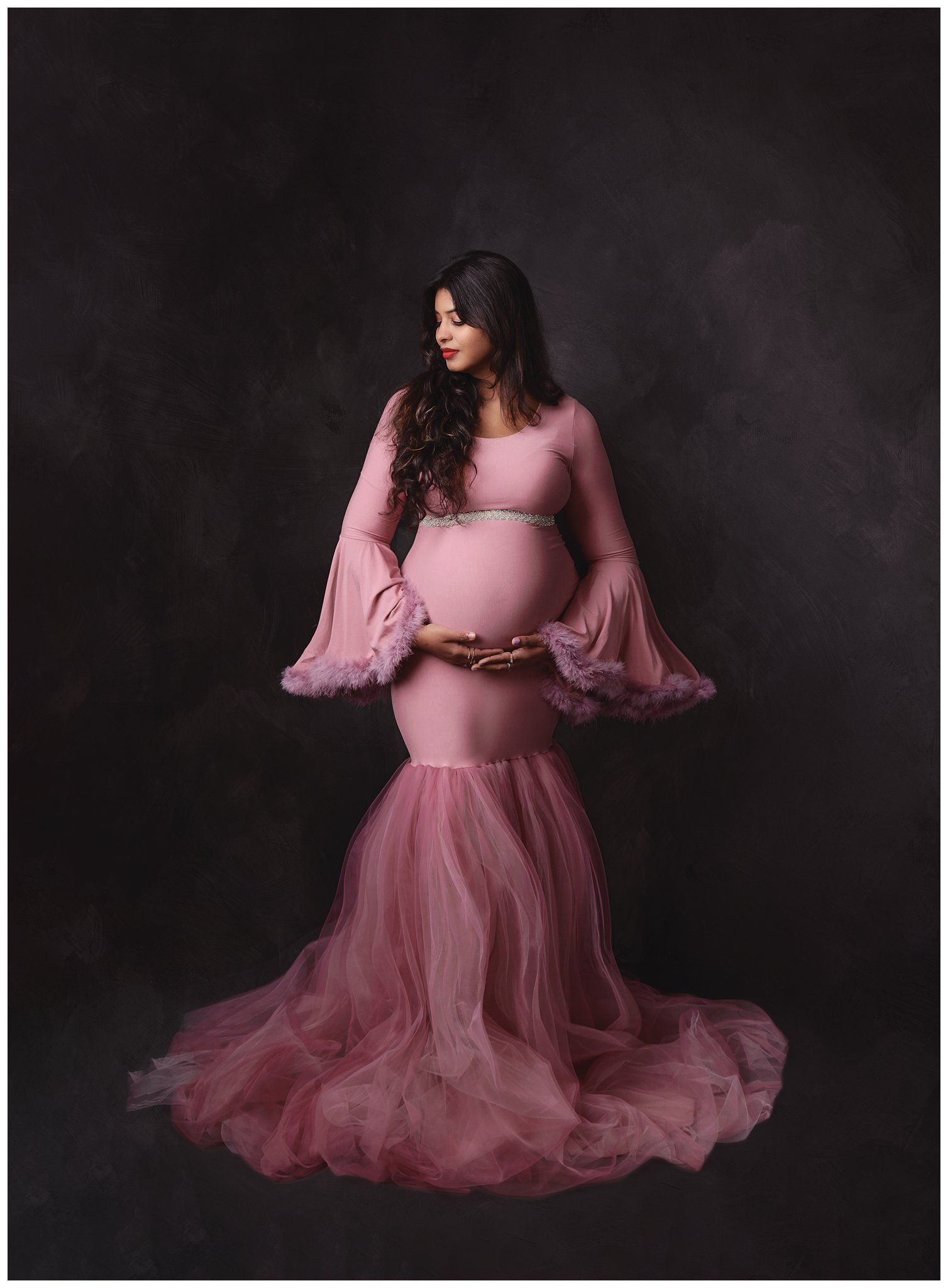 Fine art maternity portrait subject in in pink tulle gown photo by Valerie Kay Photography