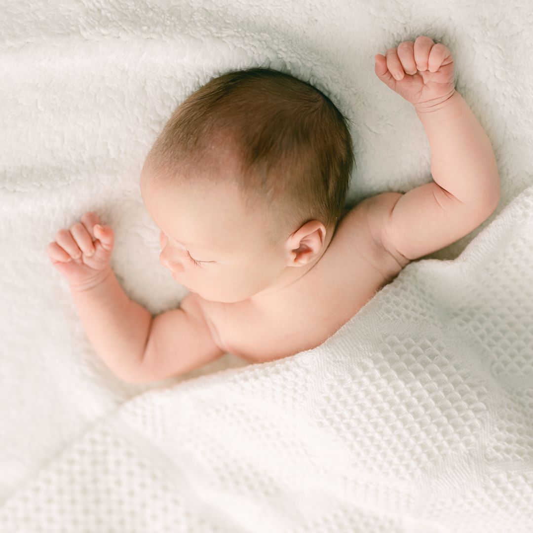 sleeping newborn in Layton, Utah for lifestyle family pictures.