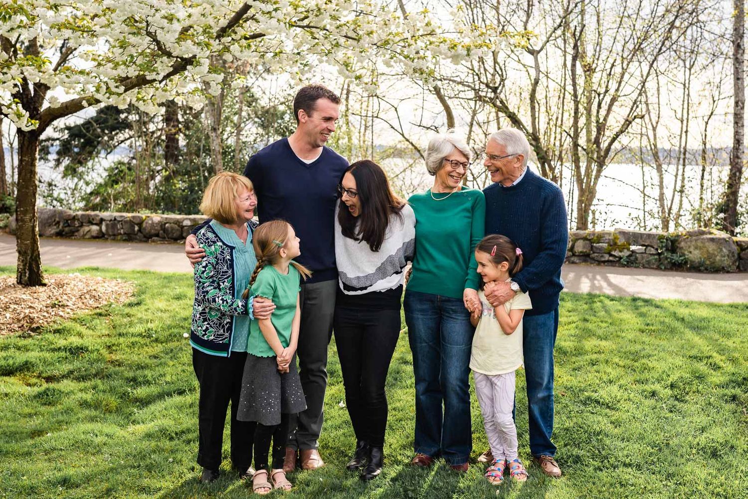 Extended family laughing on a sunny spring day.