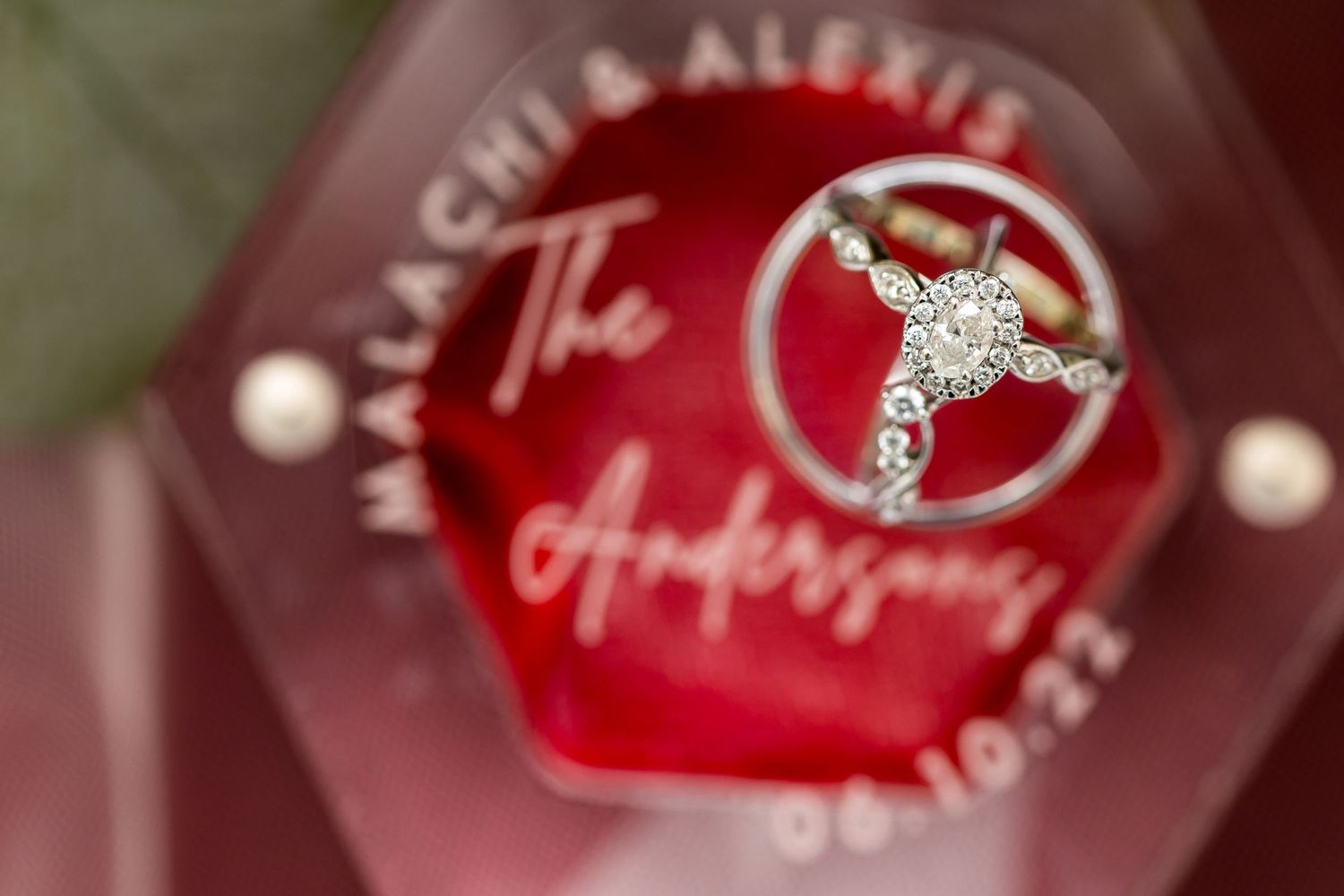 A blurred red martini glass logo with a diamond ring design in soft focus shows glamorous cocktail branding details.