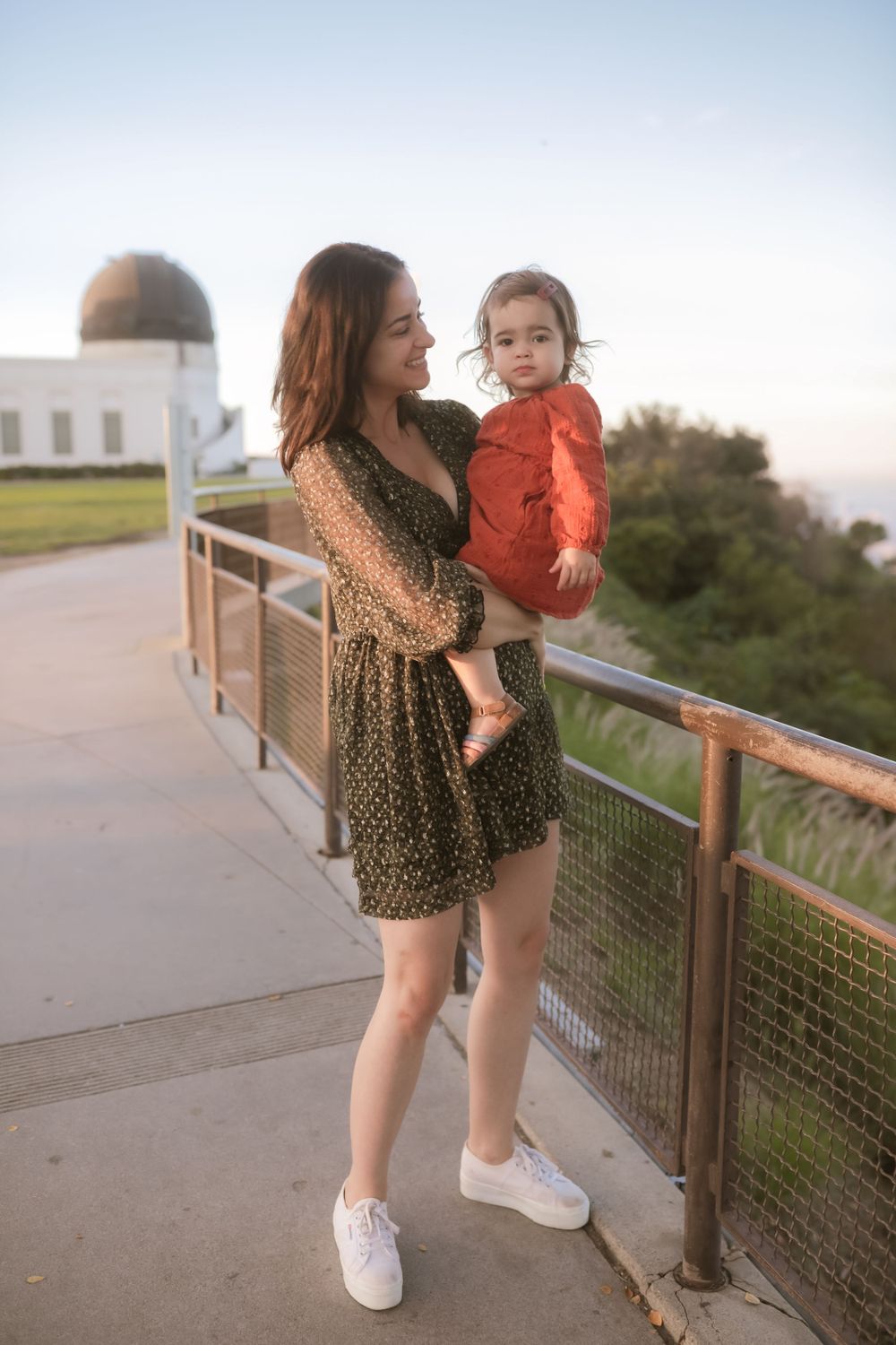 Family portrait at observatory featuring casual style and scenic backdrop.