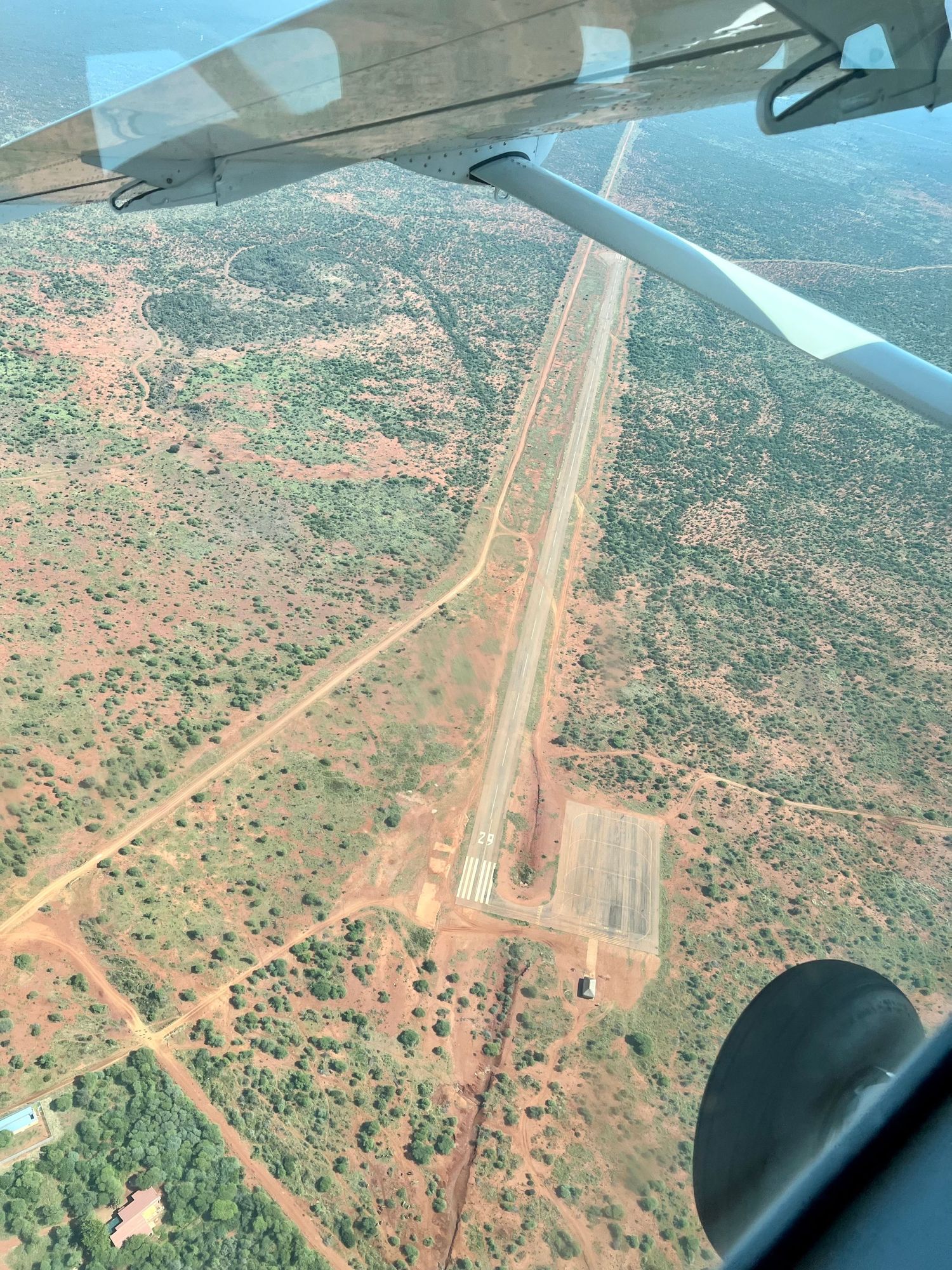 Aerial view of remote airstrip surrounded by desert landscape.