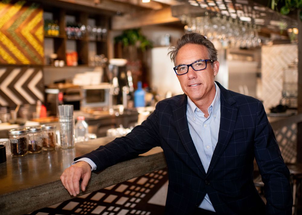 lifestyle portrait of man in suit in at caje coffee in santa barbara, ca