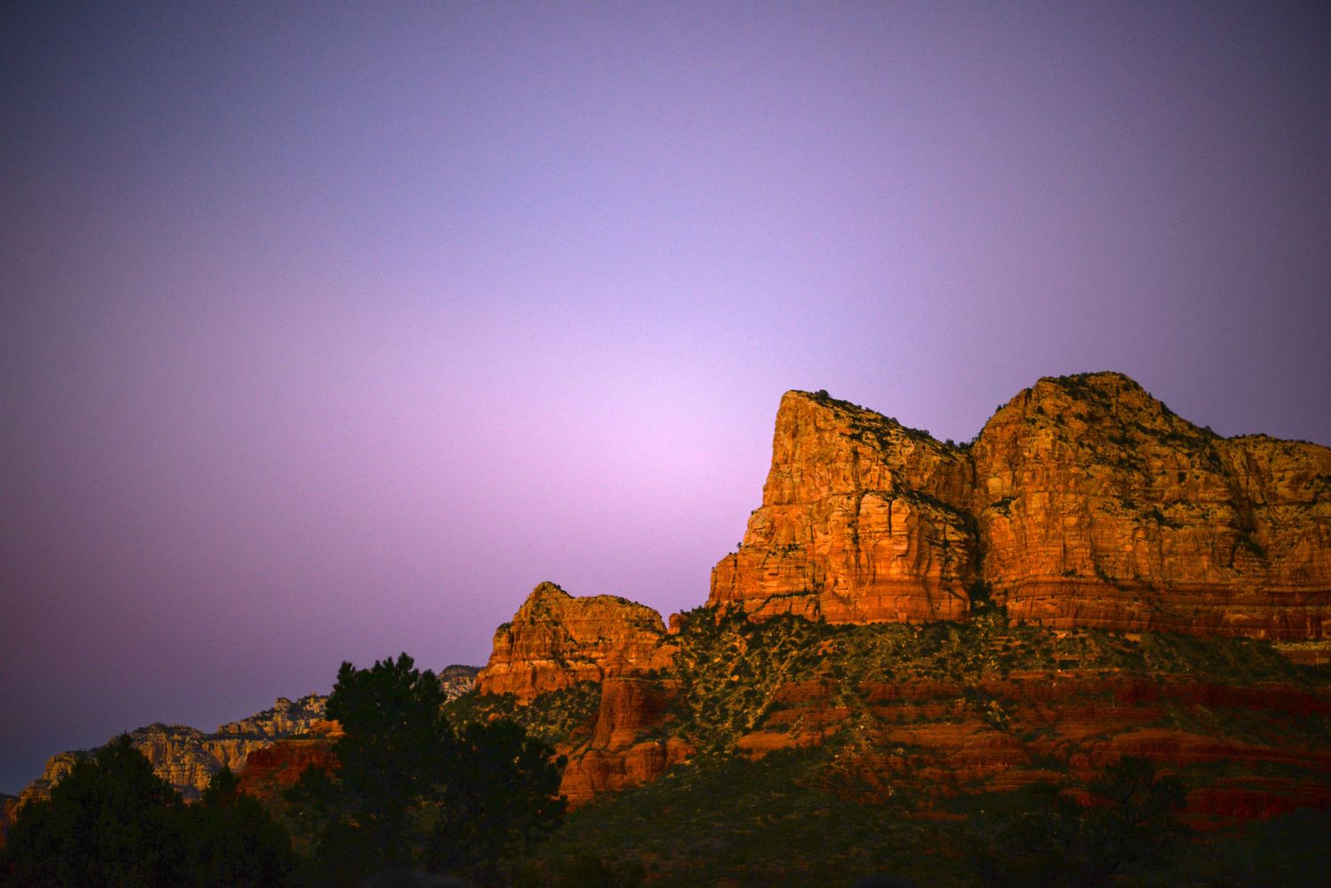 Majestic red rock cliffs of Sedona silhouetted against a purple twilight sky. Fine Art Photography