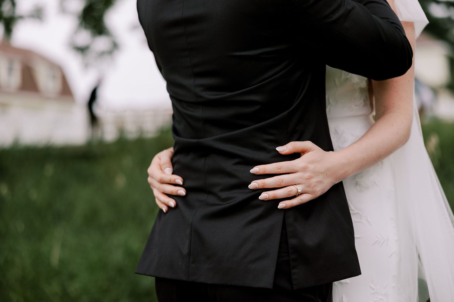 Elegant couple embracing during wedding celebration in formal attire.