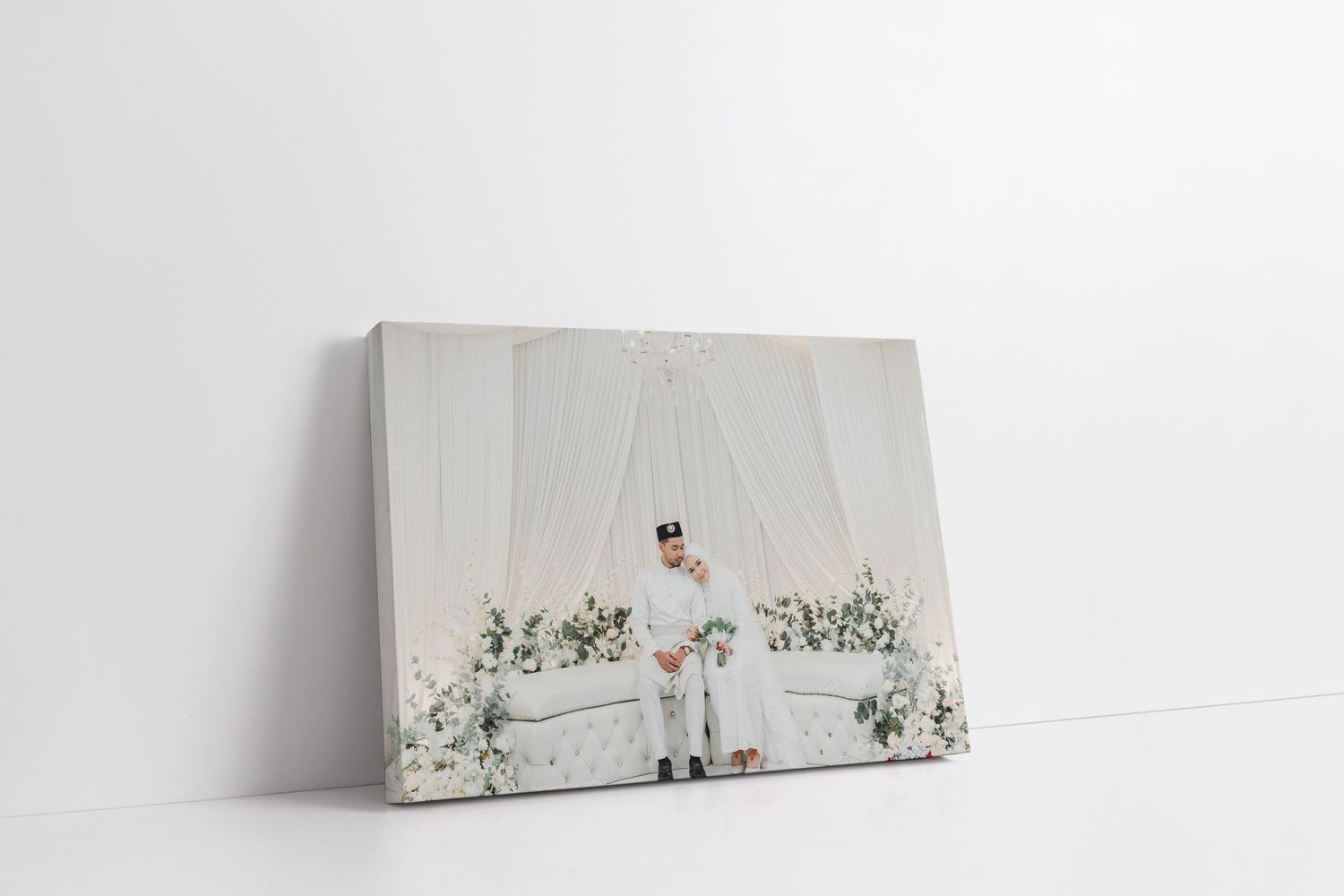 White wedding album display with subtle decorative elements against a light background.