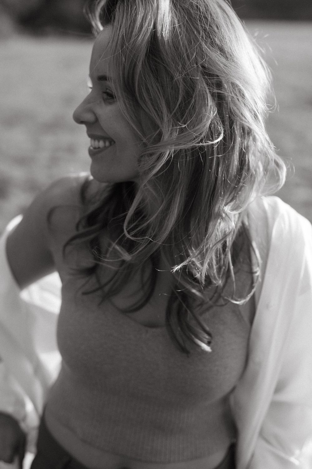 Close-up black and white portrait showing genuine laughter and joy.