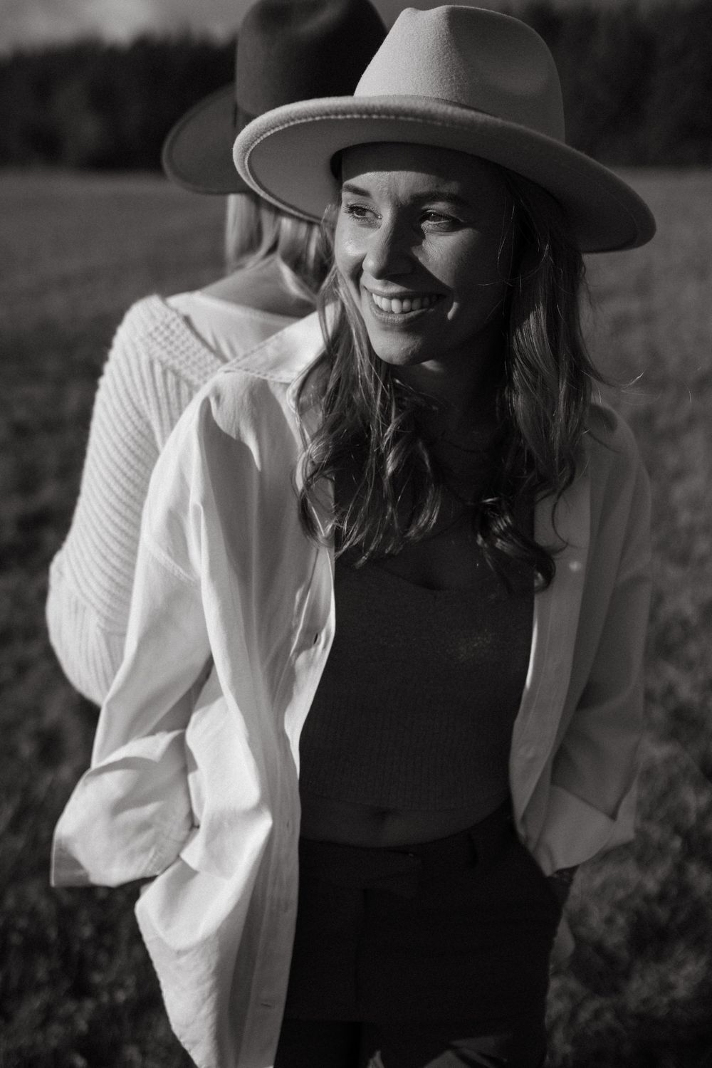 Black and white candid shots of someone wearing a hat and white blouse outdoors.