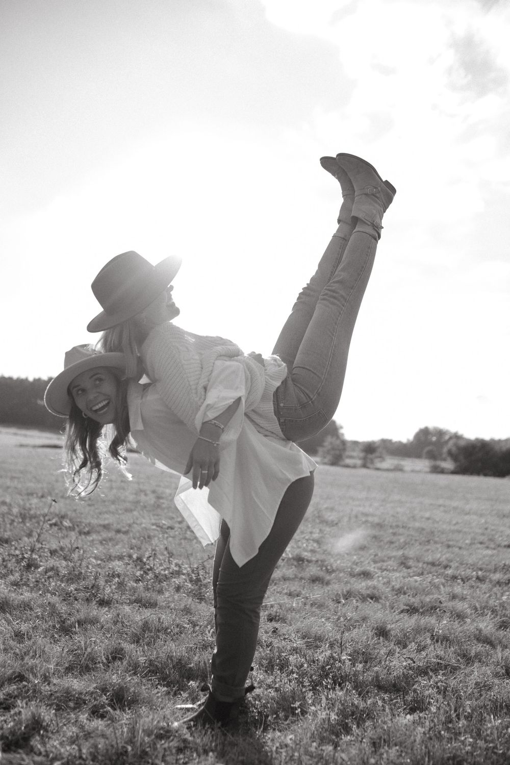 Joyful candid moments captured in black and white on a sunny field.