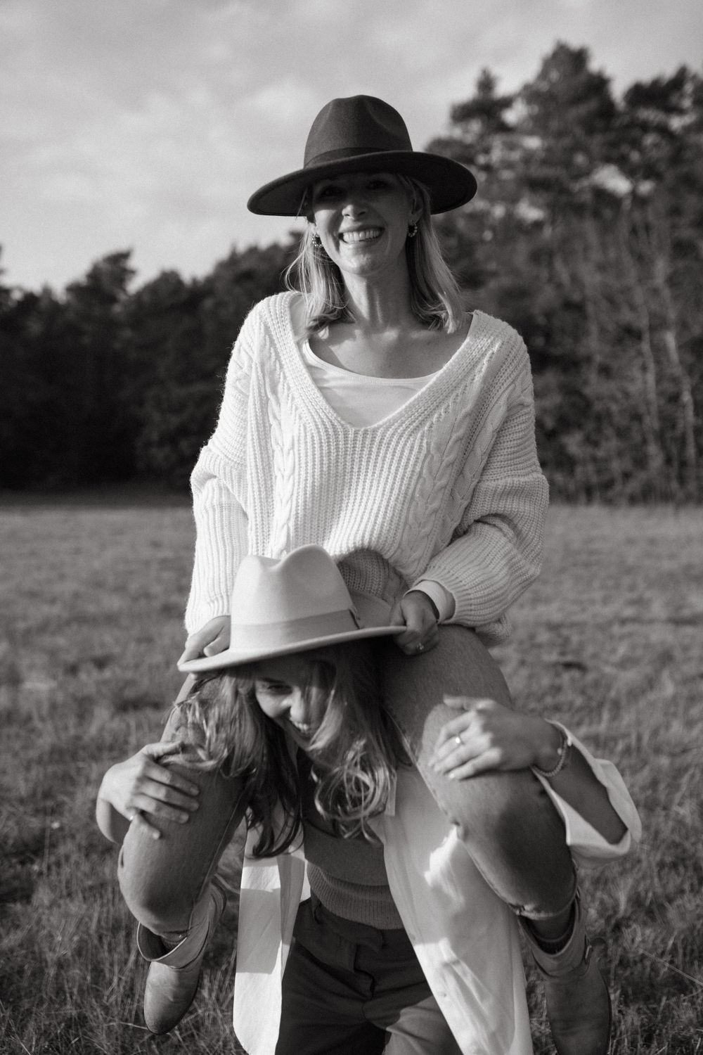 Black and white candid shots of friends sharing laughter outdoors.