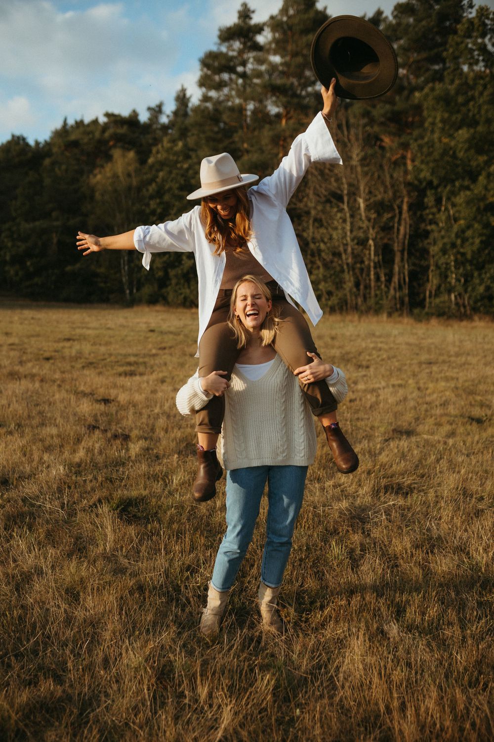 Playful piggyback rides and joyful moments captured in a golden field at sunset.
