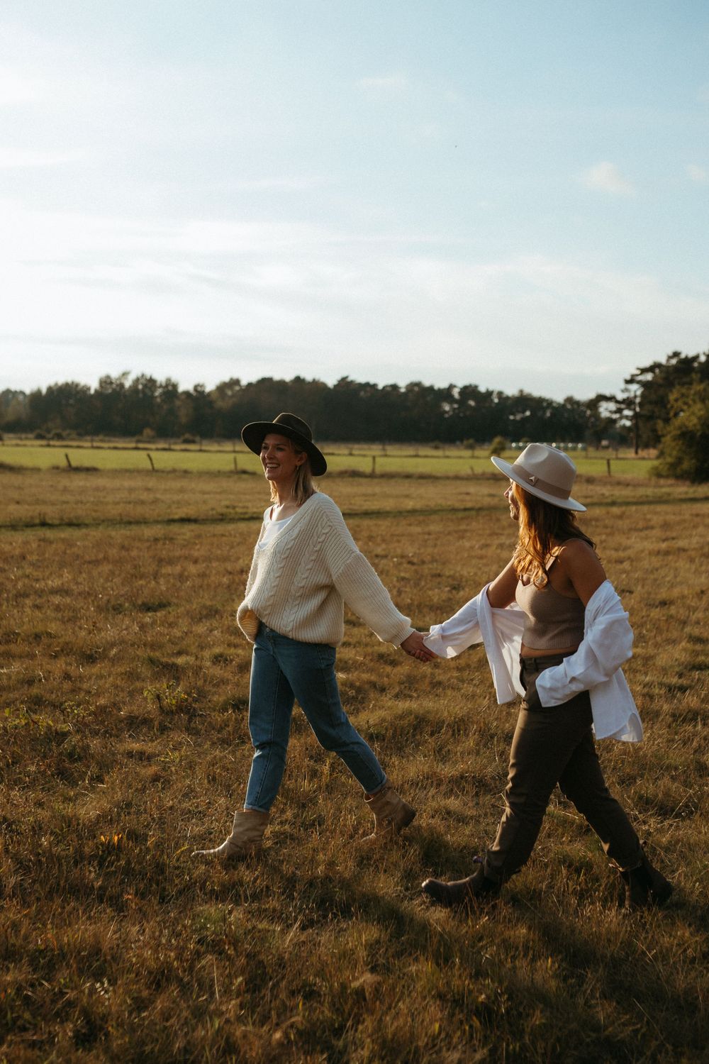 Candid shots of friends playing and dancing in a rustic field during golden hour.