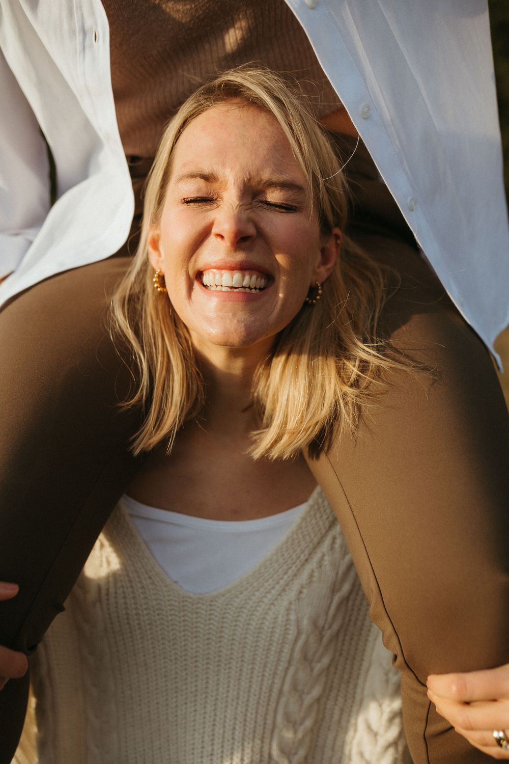 Close-up shot of joyful expressions in warm sunlight.