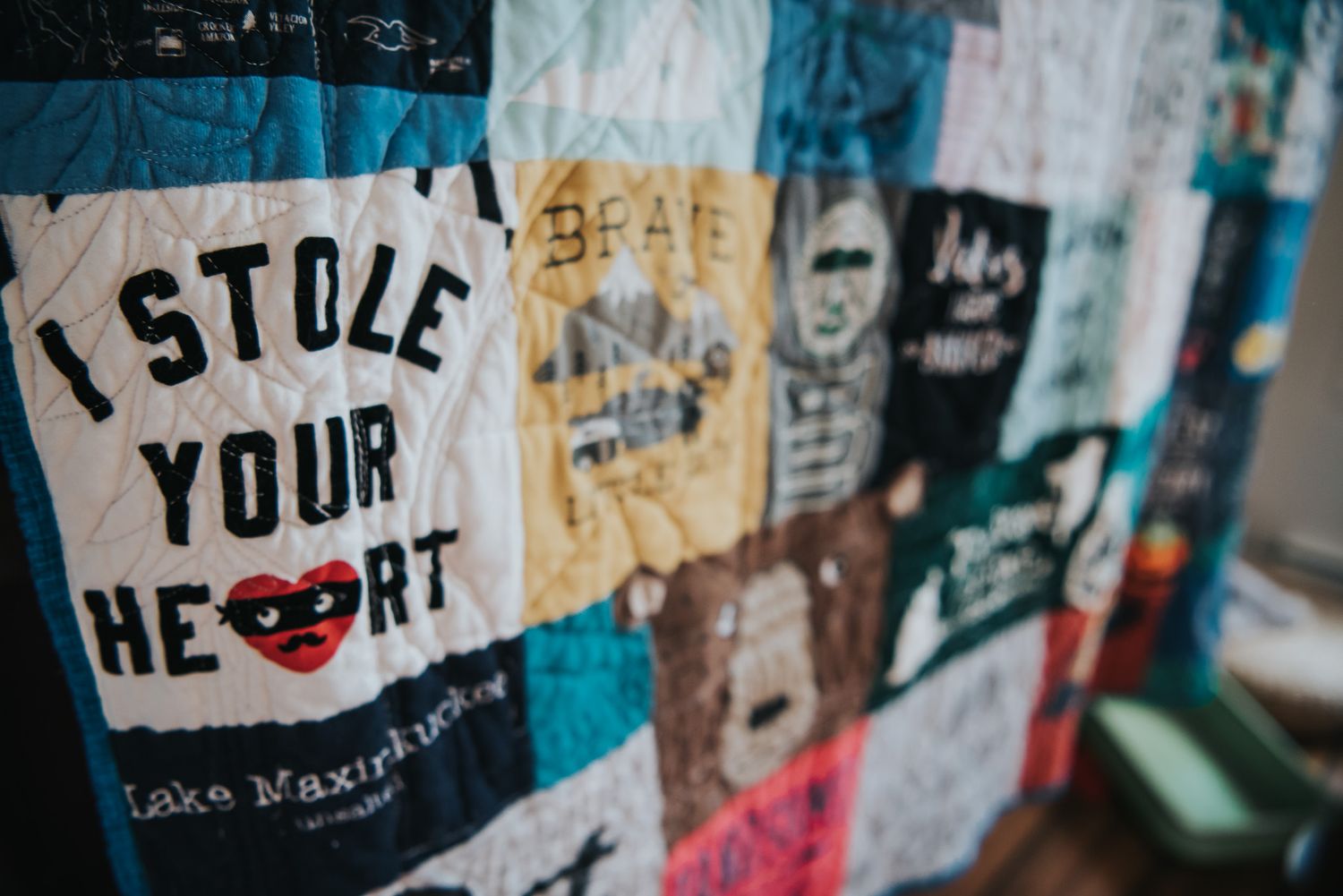 Image of a patchwork quilt with one piece in focus that reads 'I stole your heart.'