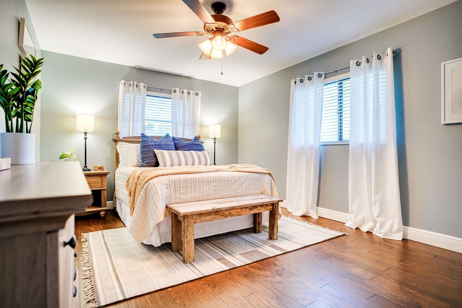 a professional real estate photo of a modern, well-decorated bedroom in a home in florida