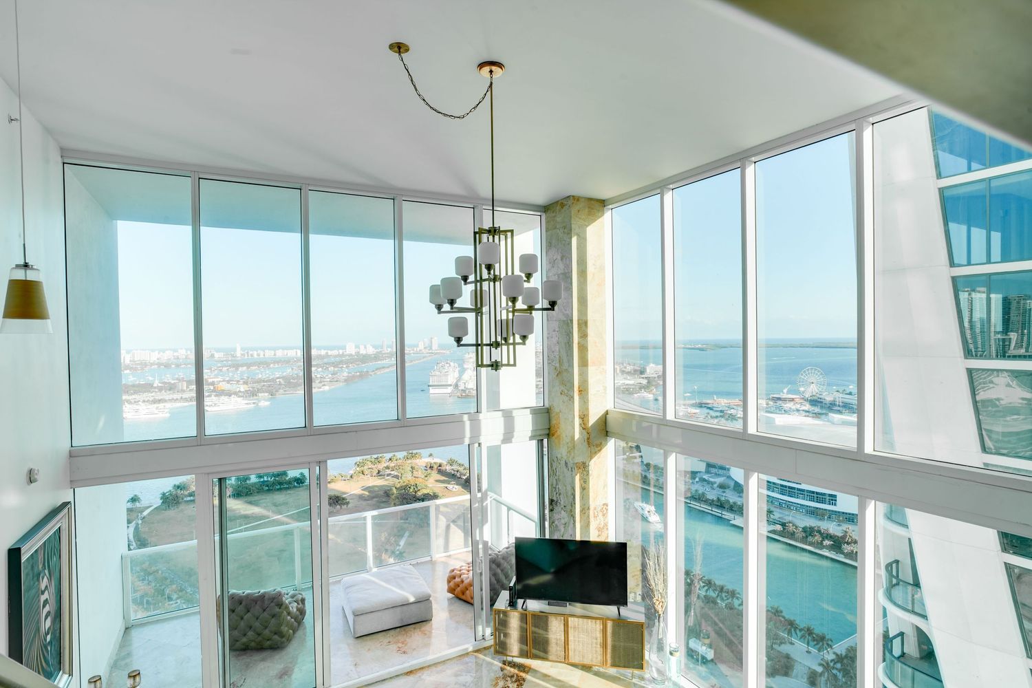a professional real estate photo of a modern, well-decorated living room in a miami condo apartment