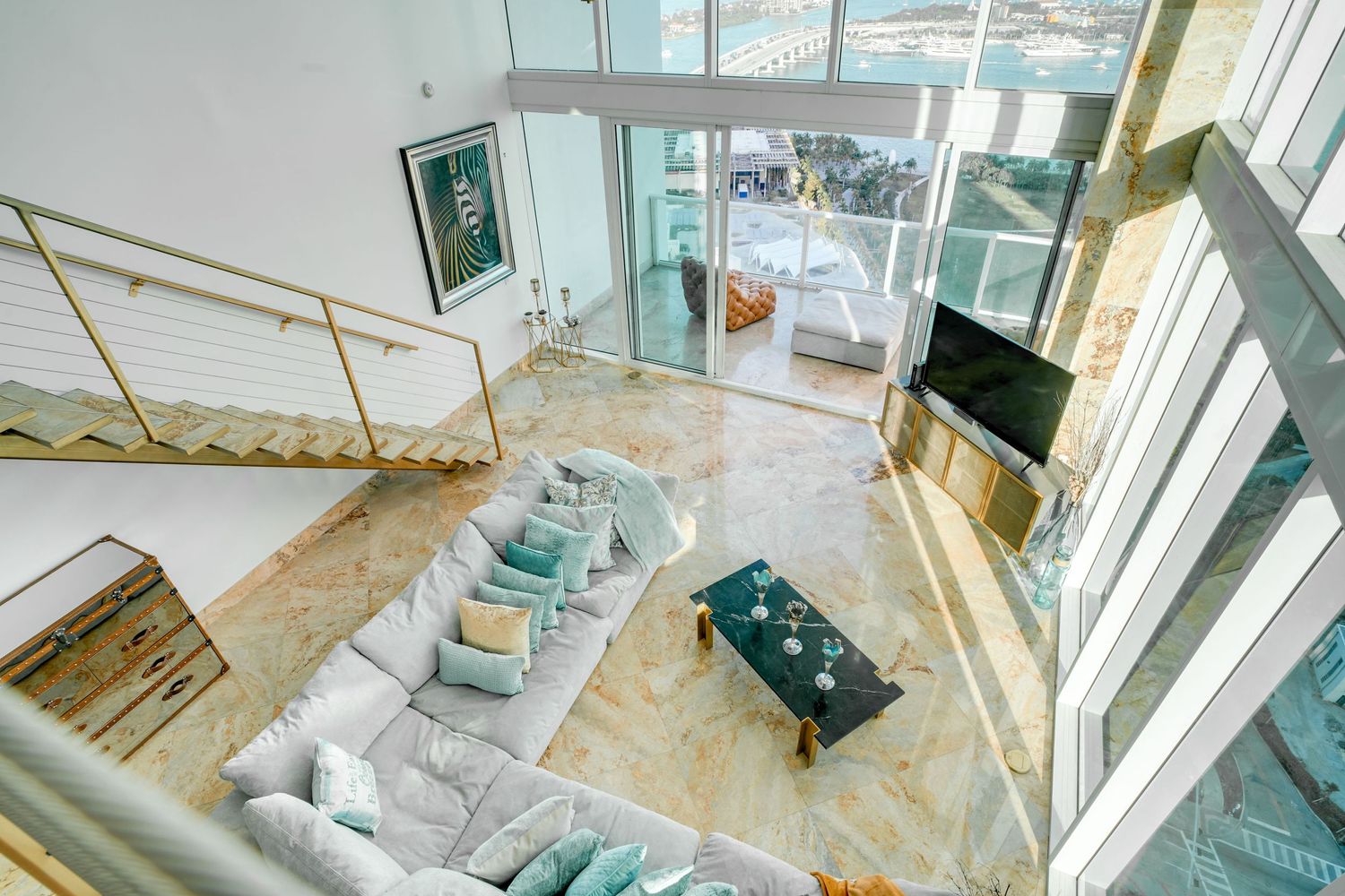 a professional real estate photo of a modern, well-decorated living room in a miami condo apartment