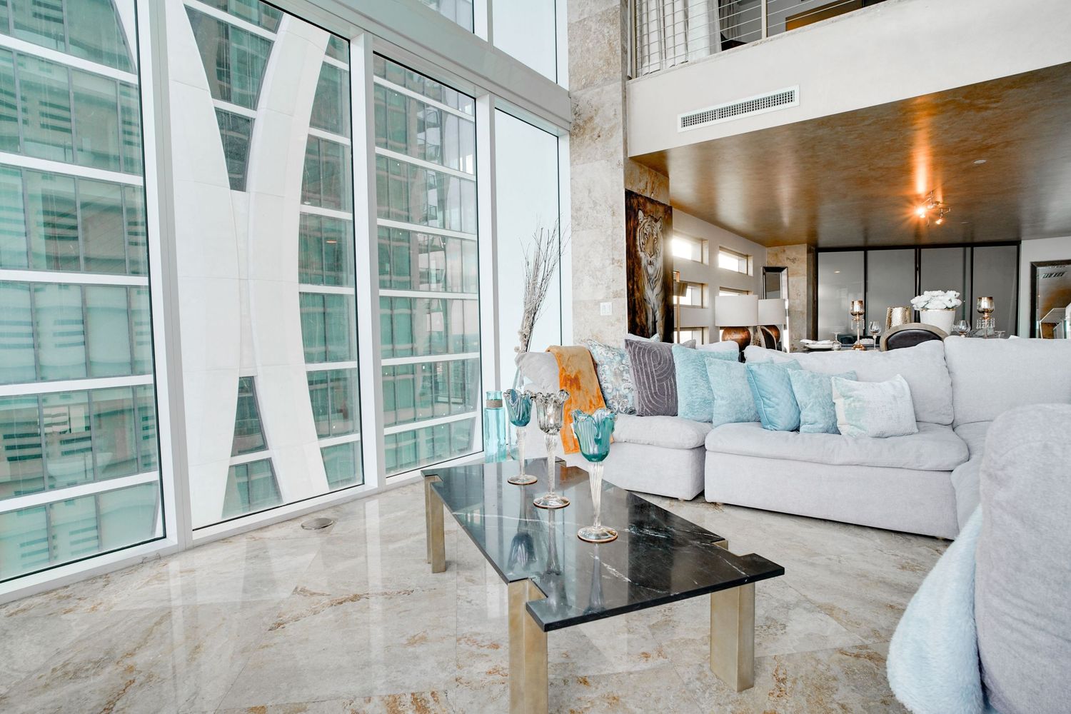 a professional real estate photo of a modern, well-decorated living room in a miami condo apartment