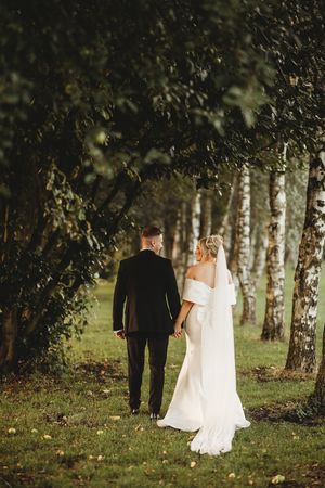warm, editorial, romantic wedding photographer 'bride and groom walking away from the camera after ceremony"