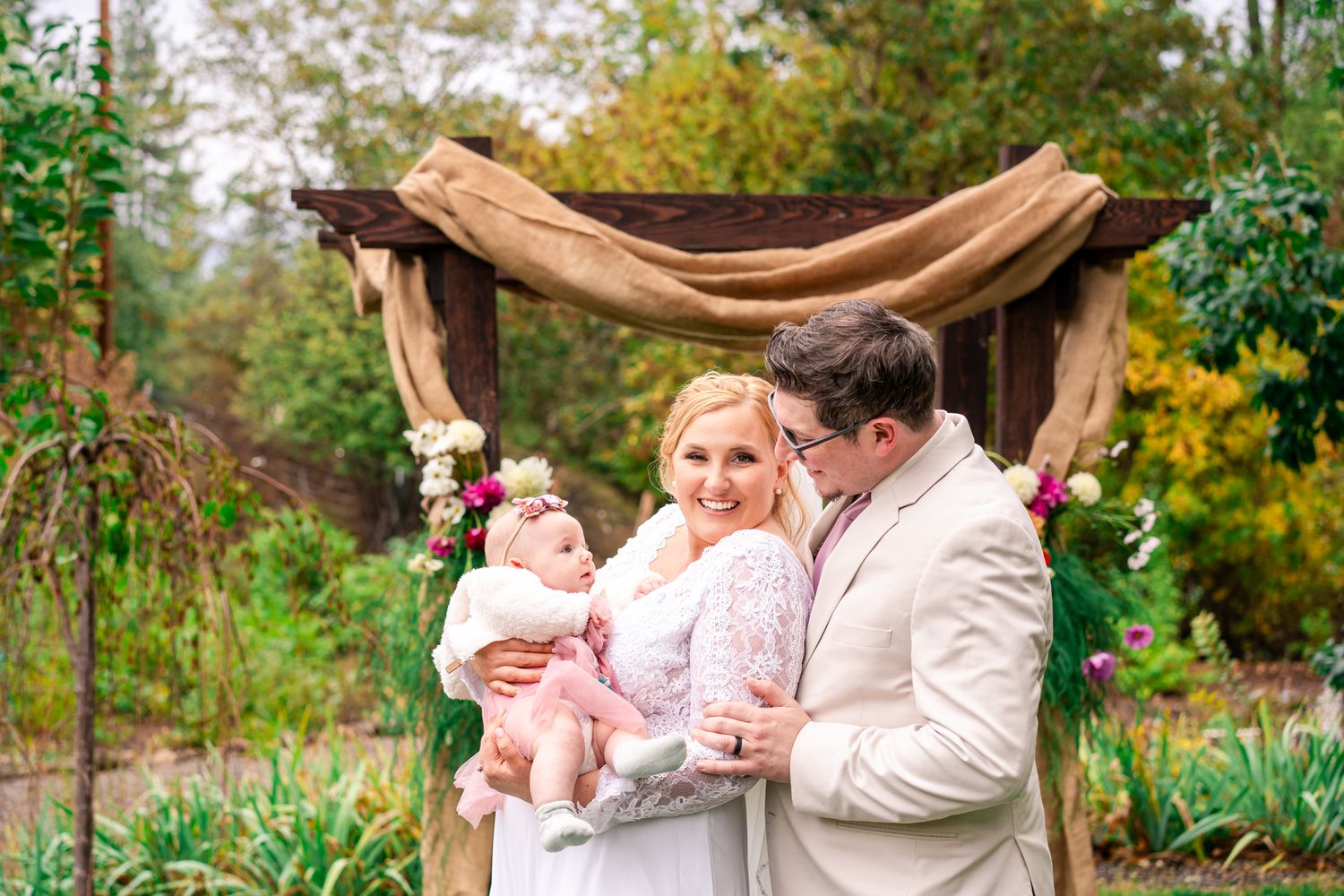 bride and groom with their baby daughter