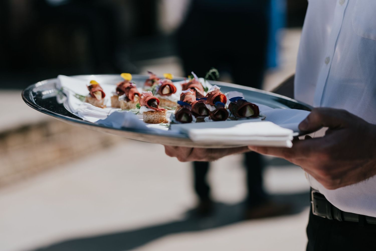 An elegant appetizer plate of hors d'oeuvres being served at an upscale event.