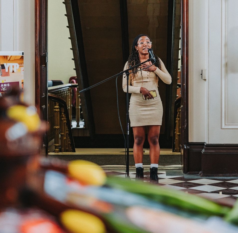 A young woman speaks passionately during a mental health event in Portland, Maine.