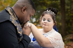 Tender wedding moment captured outdoors during autumn with lace and blue details.