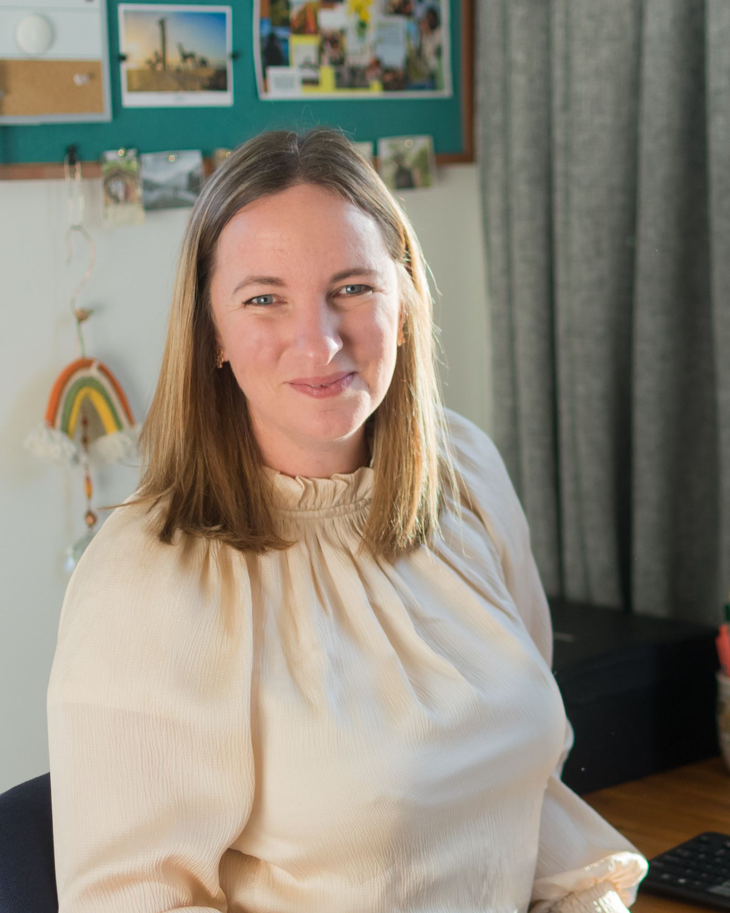 Christchurch Brand Photographer, Jasmine, smiles at the camera in her office