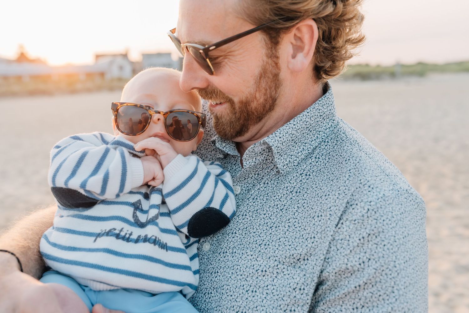 A photographer Lauren Marie photography captures a sweet moment between a father and son on the beach.