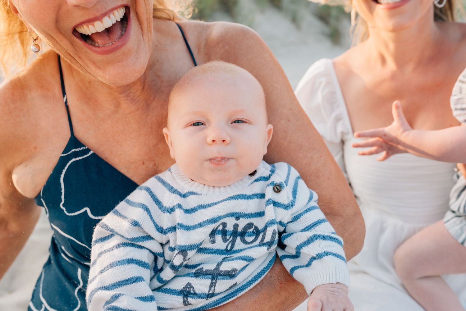 A newborn down at the NJ beach wrapped in his grandmother's arms.