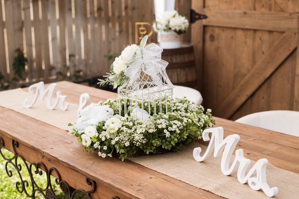 Wedding sweetheart table decor with Mr and Mrs signs and floral arrangements.