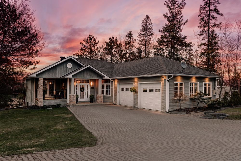 Sunset panorama of residential homes with dramatic pink and purple sky.