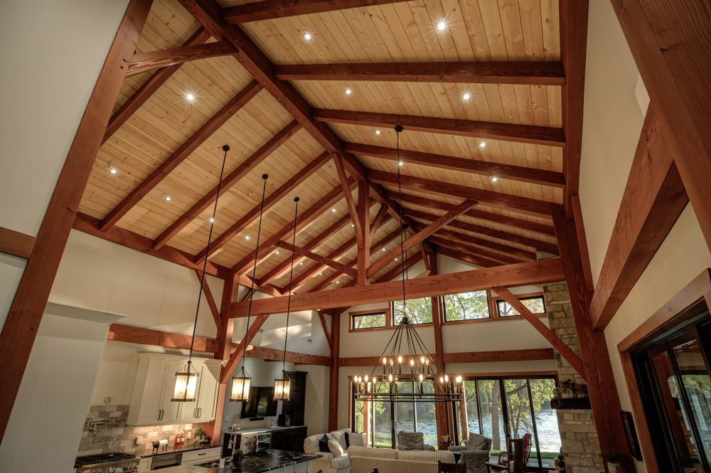 Timber frame ceiling detail with exposed wooden beams and recessed lighting.