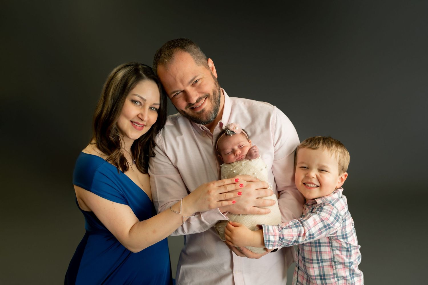 Family portrait series showing parents with young children against grey studio background.