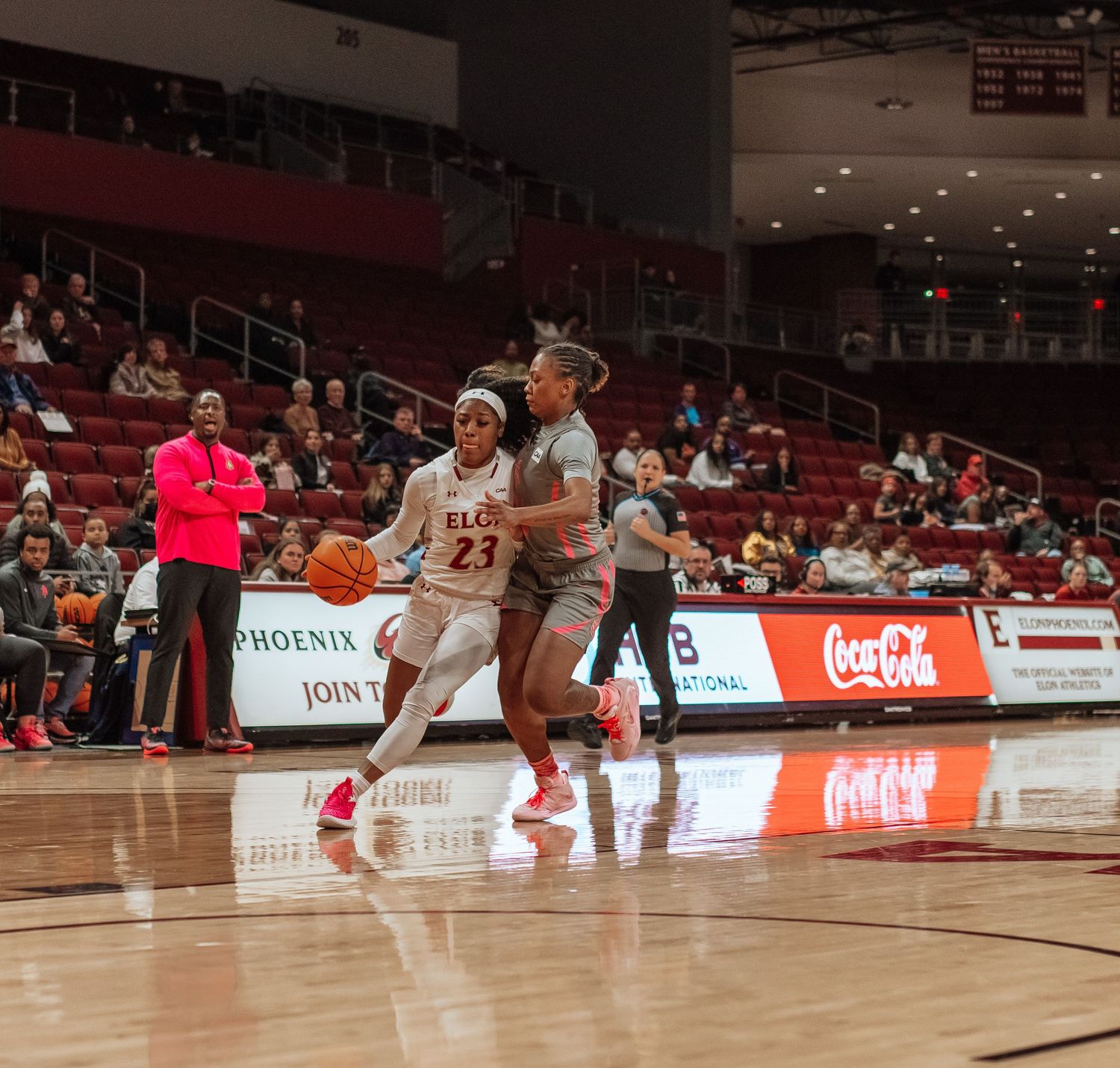 Basketball players compete for possession during an intense game.