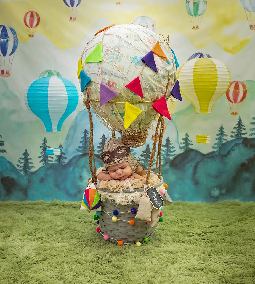 Adventure themed nursery photo with hot air balloon and forest backdrop.
