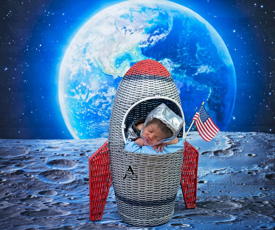 Whimsical space-themed photo with rocket ship prop against moon and Earth background.