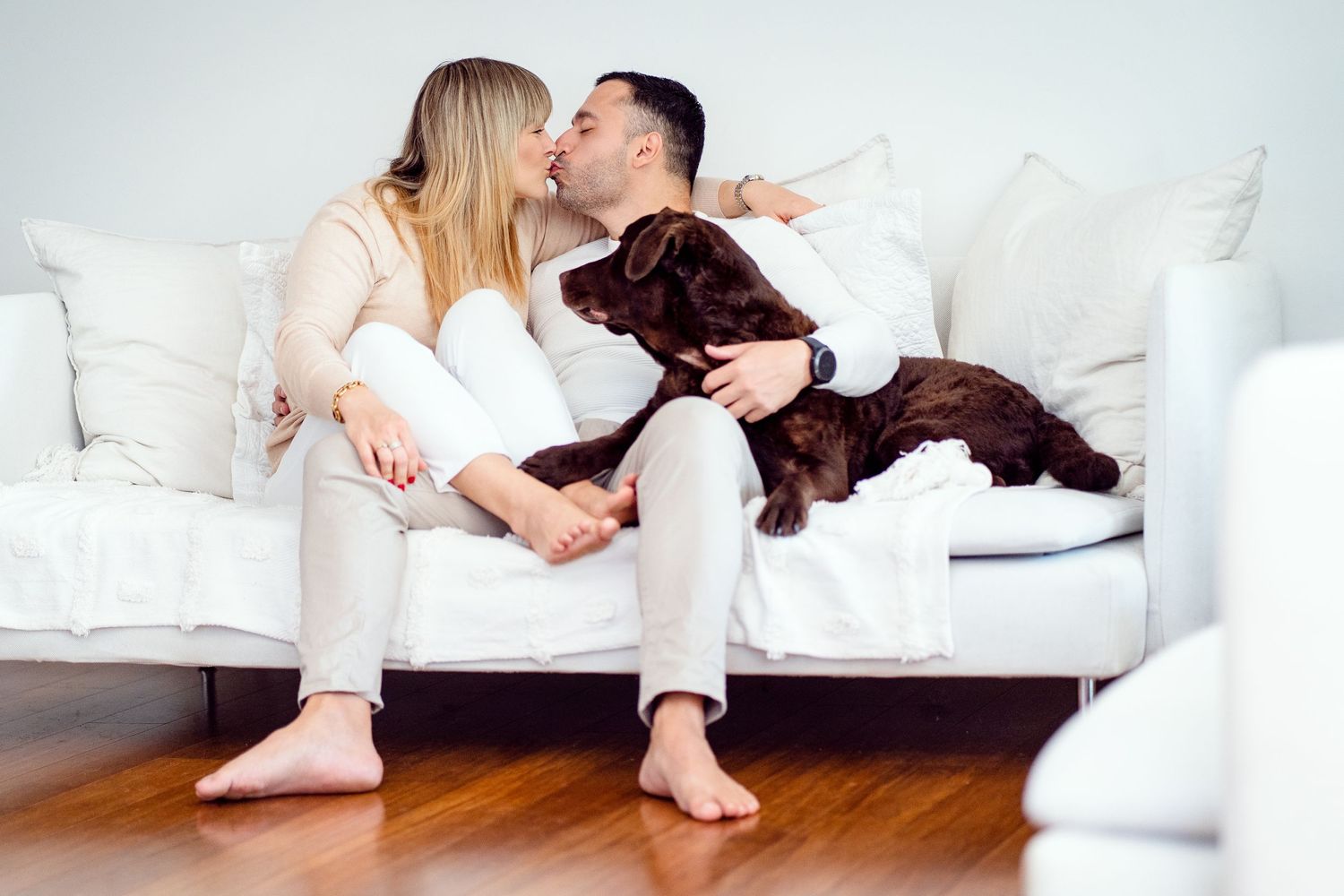 kissing couple during a photoshoot in Balgowlah with their Labrador