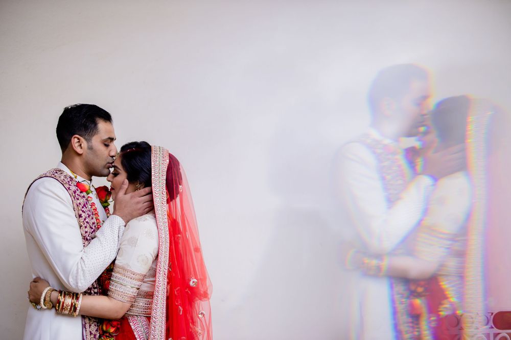 Artistic wedding portrait with couple's reflection creating a dreamy double exposure effect.