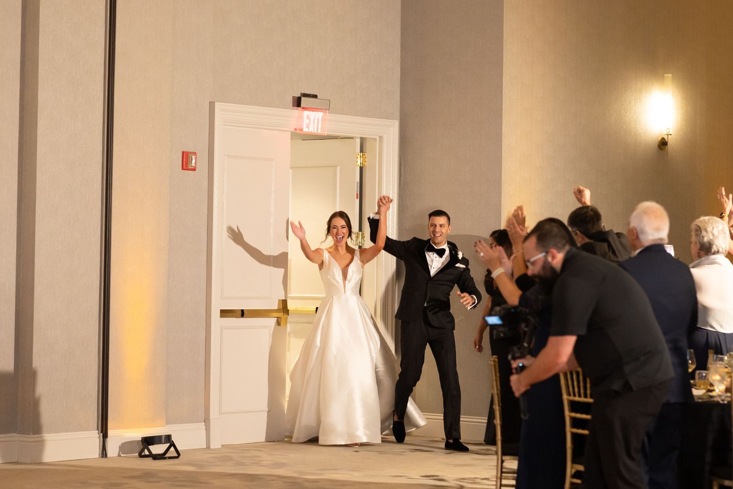 Wedding reception venue with guests watching a celebration on the dance floor.