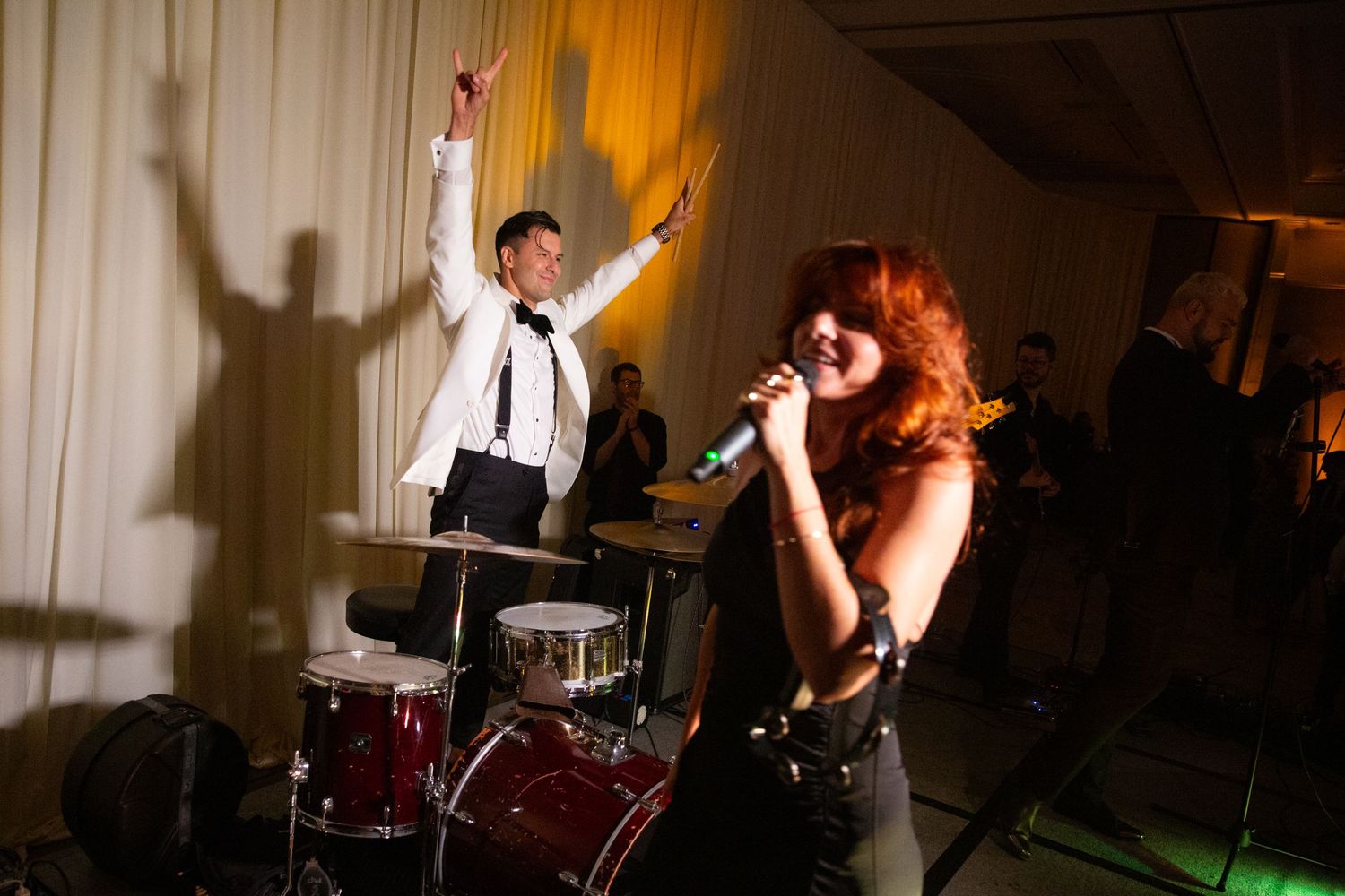 Wedding reception entertainment with live band performing for dancing guests.