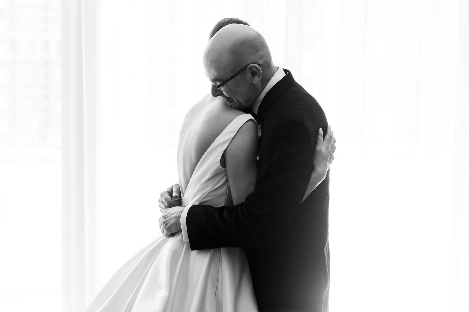 Emotional black and white wedding photographs capture intimate embraces.