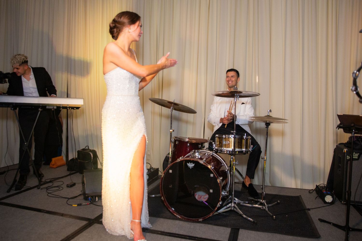 Wedding party celebrations with live music and dancing at an indoor venue.