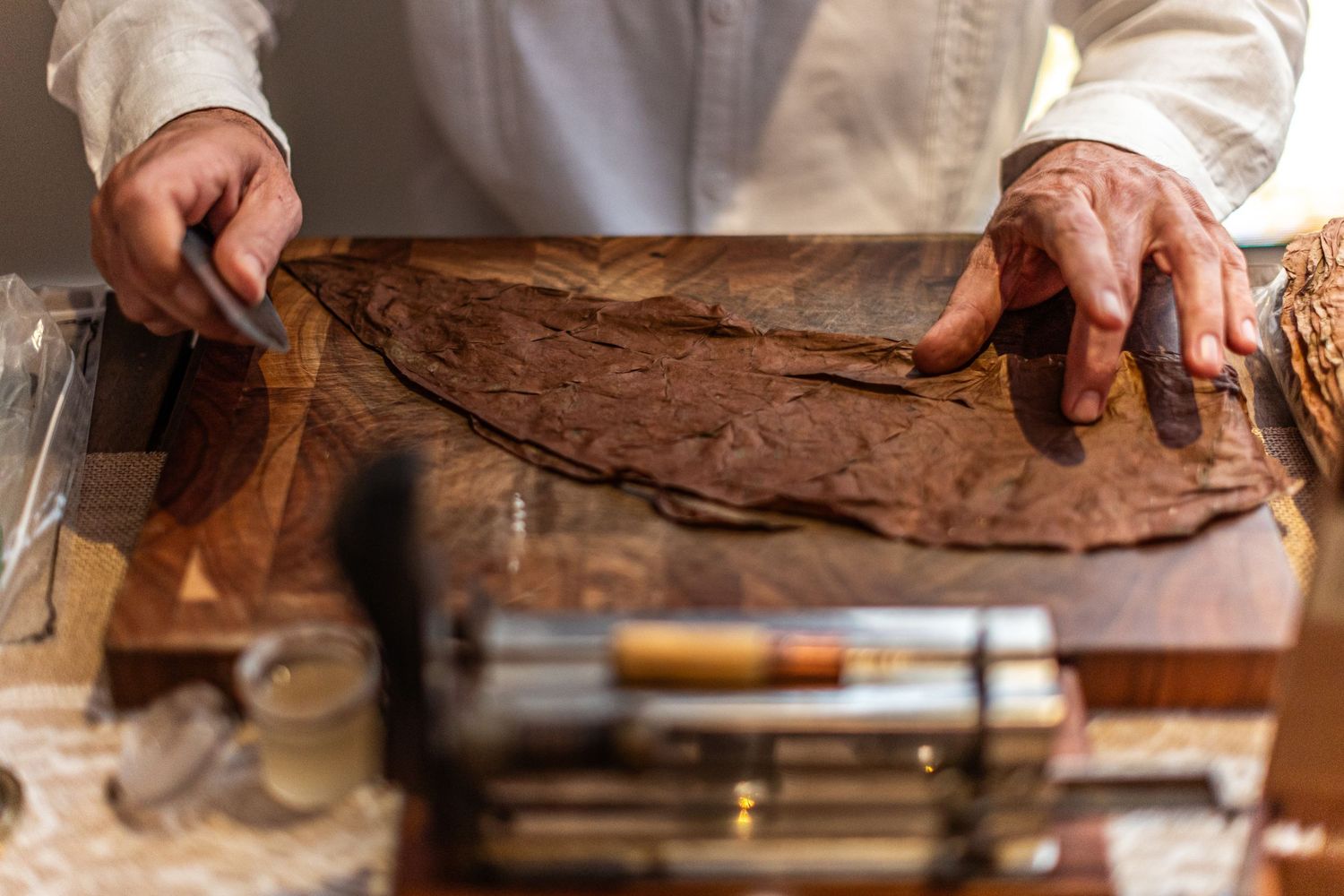 Chef preparing fresh bread and pastries in a professional kitchen.