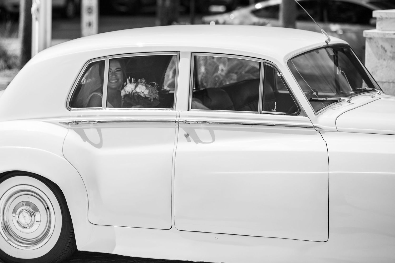 Classic white vintage cars lined up for a wedding celebration.