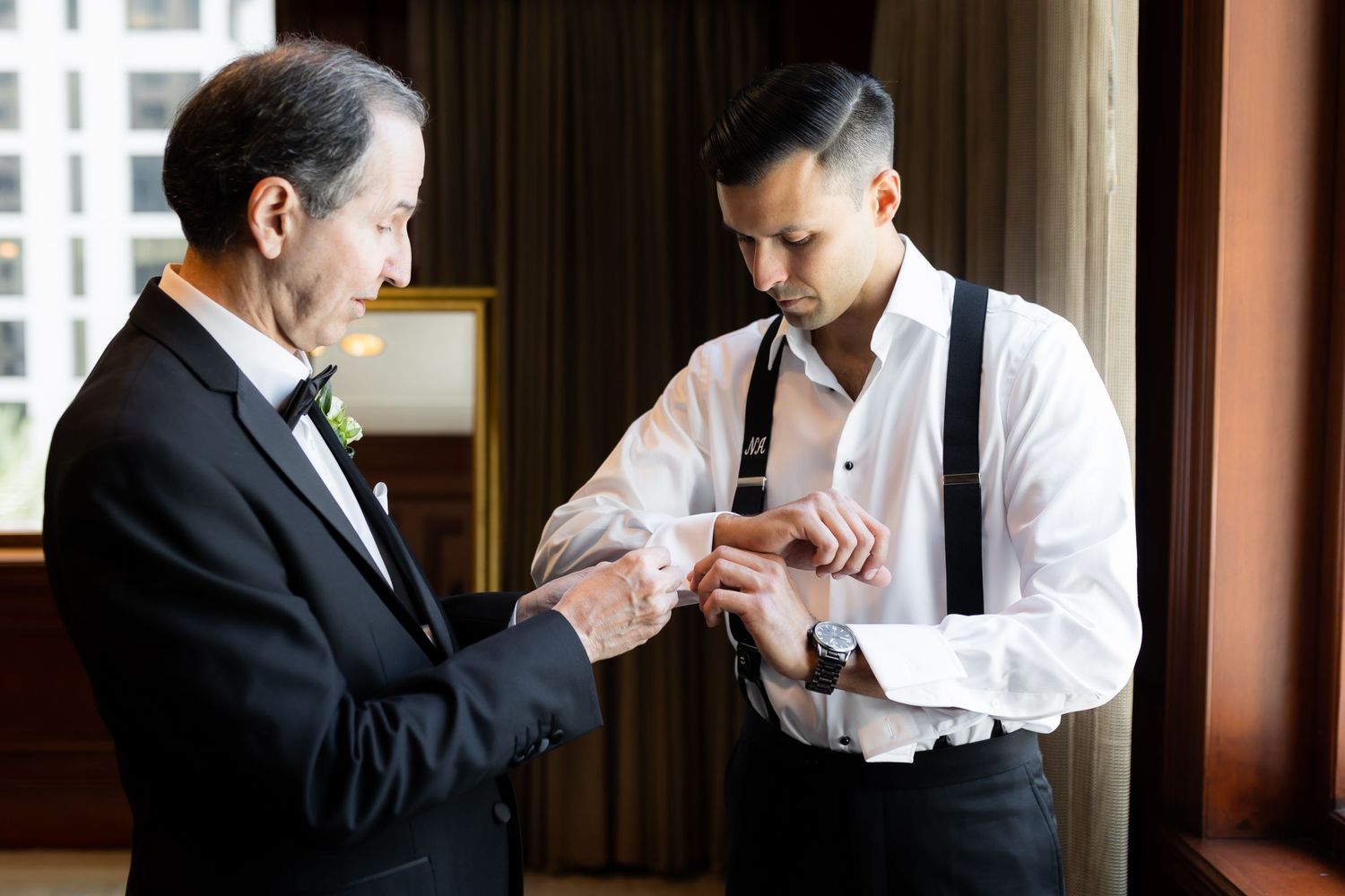 Formal wedding preparation scene with suits and ties.