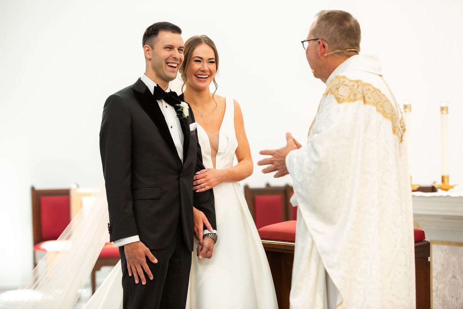 Couples and guests celebrate joyfully during wedding reception in formal attire.
