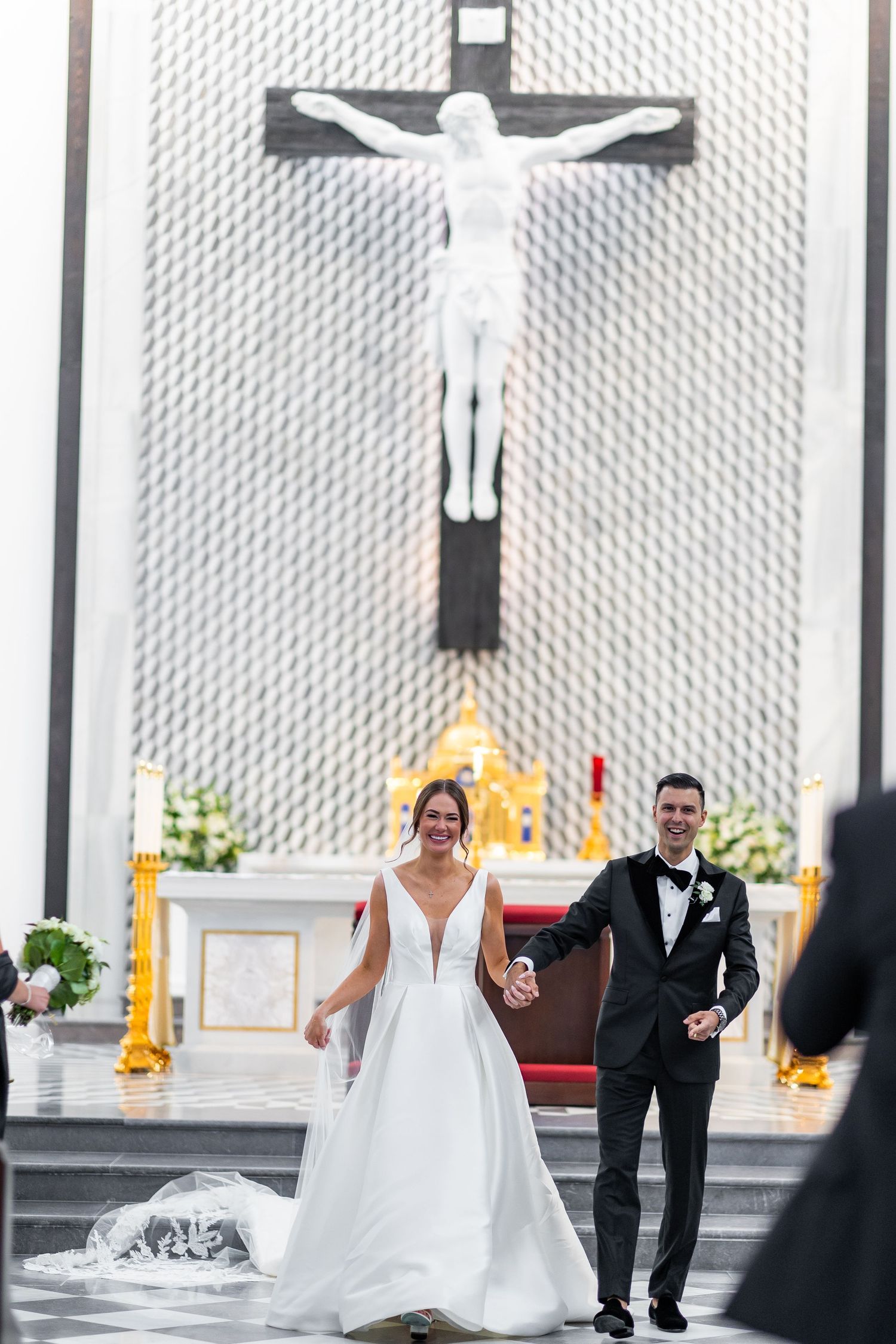 A wedding celebration unfolds in a contemporary church setting with geometric wall designs.