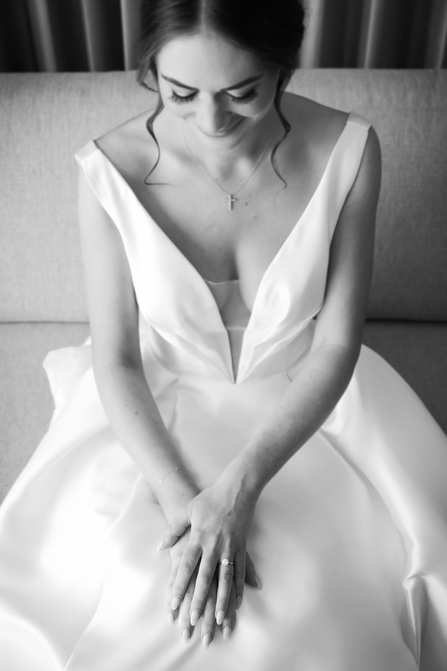 Artistic black and white detail shots of wedding dress and hands.