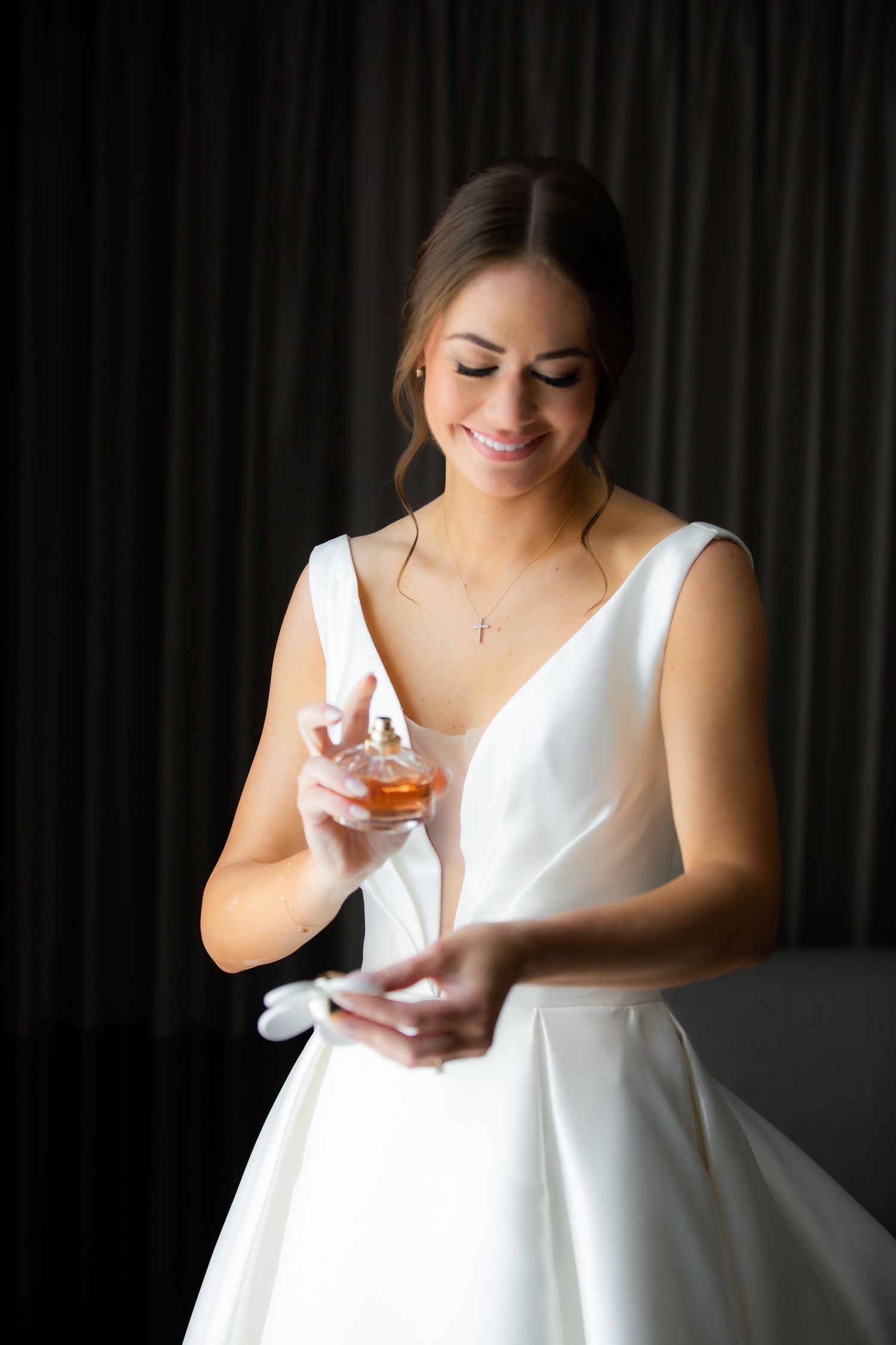 Close-up details of a classic white wedding dress with modern V-neckline.